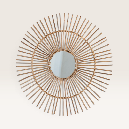 Vintage Industrial Madi round wall mirror with a handcrafted sunburst frame made of natural rattan and bamboo.
