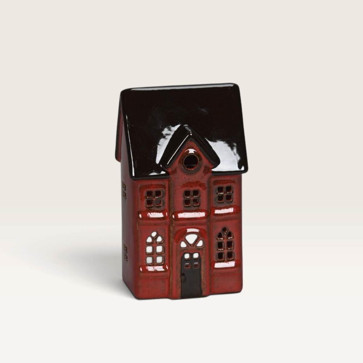 Vintage Industrial red porcelain house ornament with a glossy finish and detailed architectural cutouts.