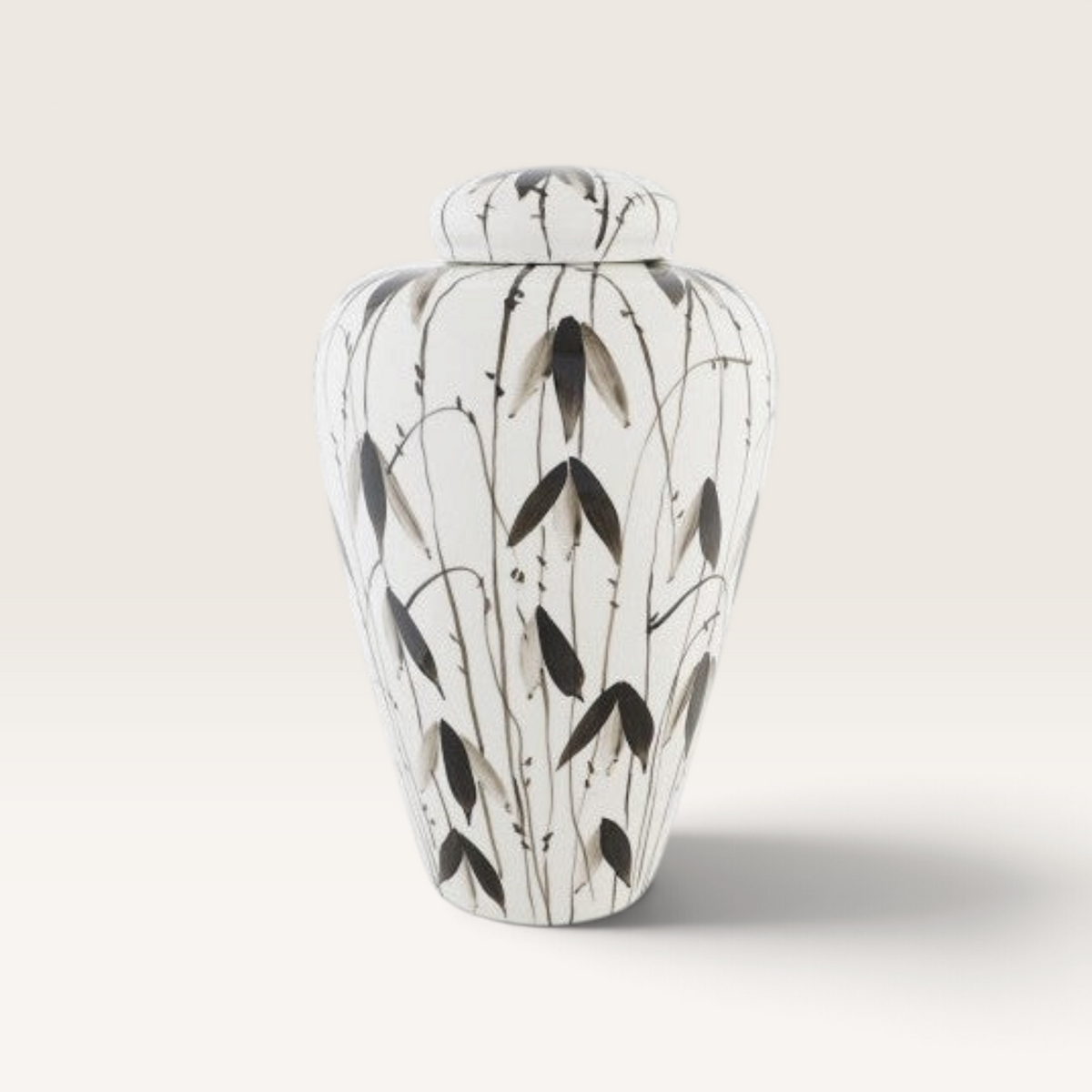 Vintage Industrial Tibor Fayún porcelain vase with hand-painted black botanical leaf patterns on a white background.