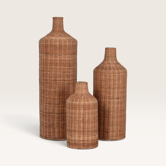 Vintage Industrial Trang set of three tall cylindrical vases made from woven rattan and metal in a natural finish.