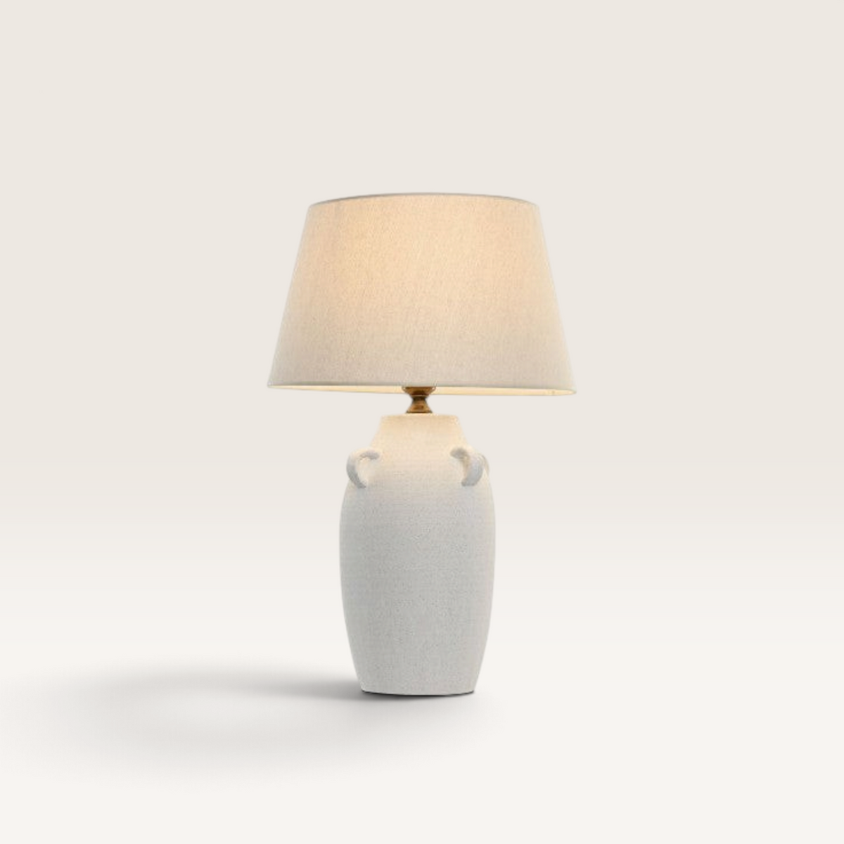 Vintage Industrial Marbu table lamp with a white porcelain base, decorative handles, and a beige linen lampshade.