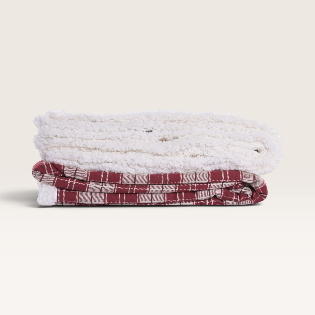 Vintage Industrial Manta Kupang red plaid cotton throw blanket with a soft white sherpa lining folded on a surface.