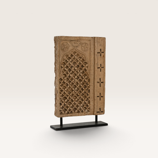 Vintage Industrial Escultura Pateng stone sculpture with intricate floral carvings on a black metal display stand.