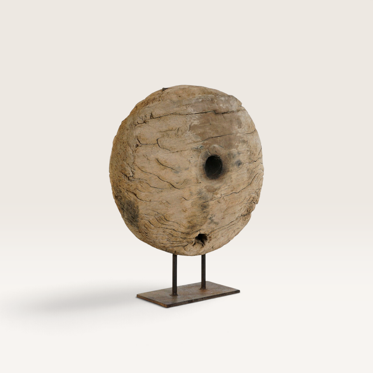 Vintage Industrial Nerac sculpture featuring a weathered circular wooden wheel on a rustic iron stand.