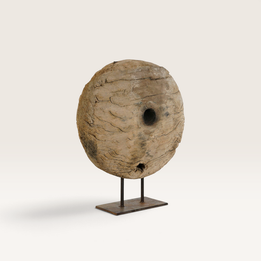 Vintage Industrial Nerac sculpture featuring a weathered circular wooden wheel on a rustic iron stand.