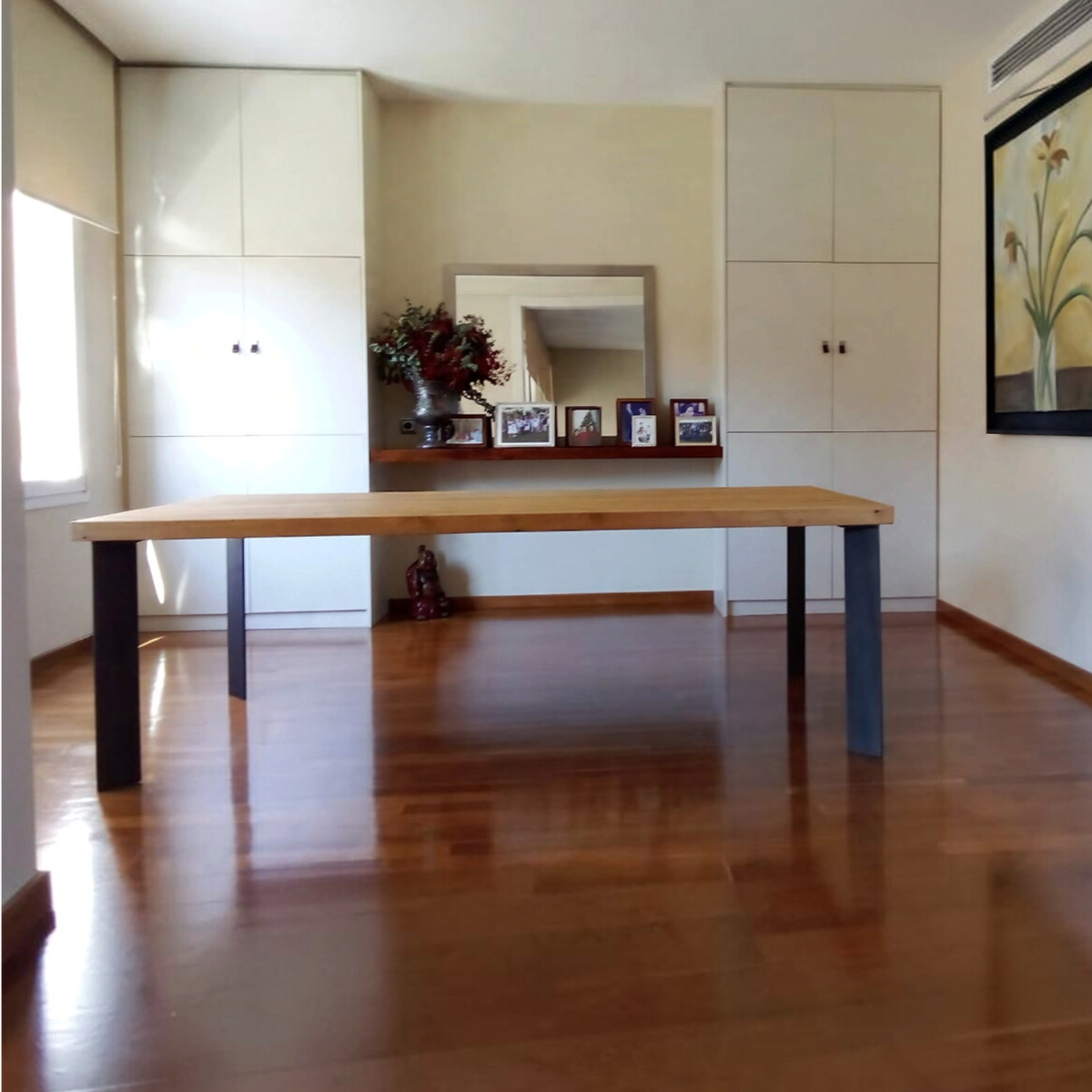 Vintage Industrial Kalumi dining table with solid pine wood top in Arena finish and black iron legs in a home setting