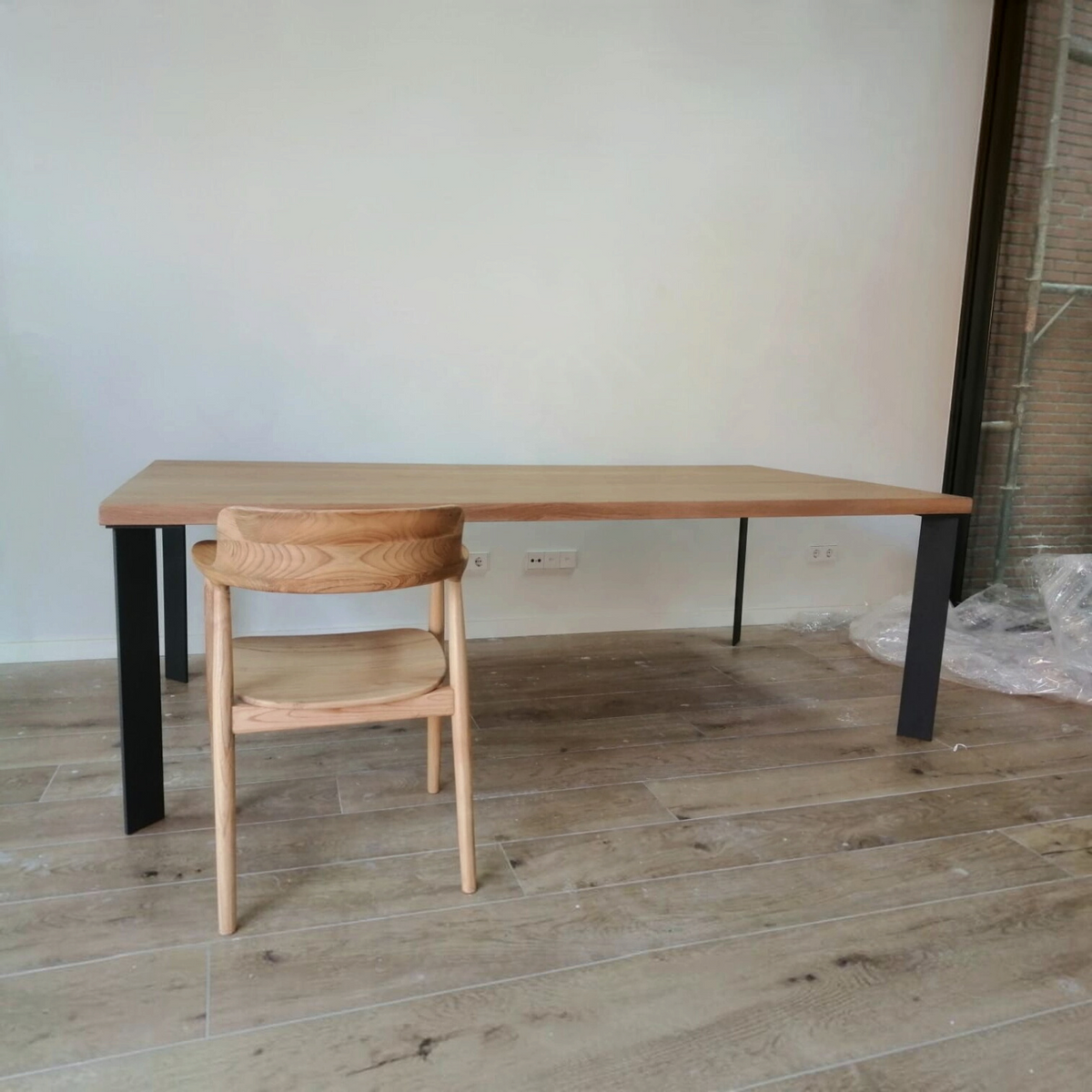 Vintage Industrial Kalumi dining table in Arena pine wood with black iron legs and a matching wooden chair
