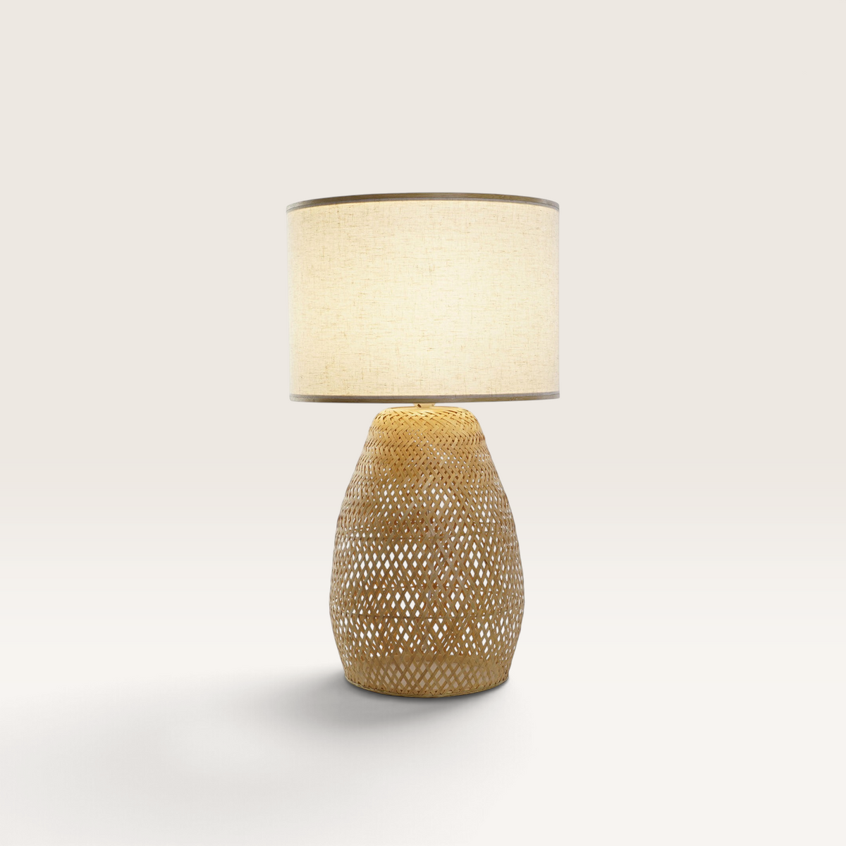 Vintage Industrial bamboo table lamp with a natural woven base and a beige fabric drum shade for warm lighting.