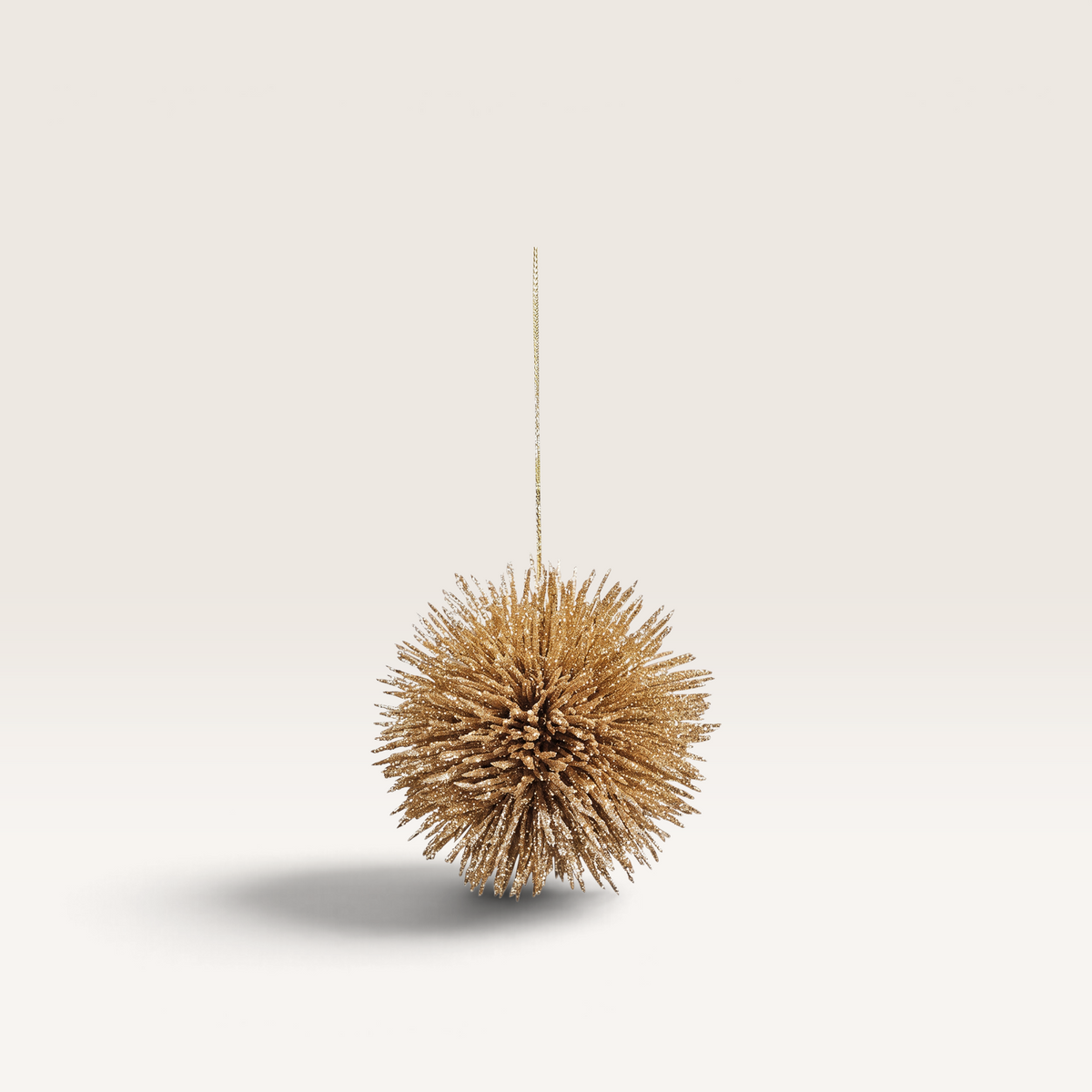 Vintage Industrial Colgante Pino ornament in aged gold with a spiky, starburst design for elegant home decor.