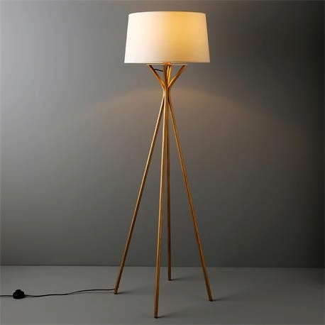 Vintage Industrial Diane floor lamp with a slim metallic tripod base and a warm glowing fabric drum shade