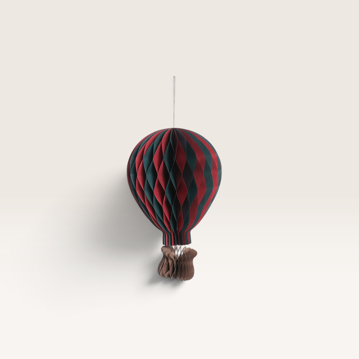 Vintage Industrial hanging hot air balloon paper decorations in red, green, and cream for festive home decor.